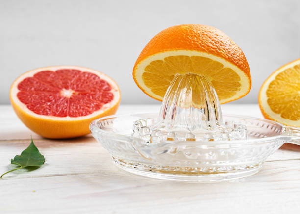 Manual Glass Citrus Juicer and Citrus Fruit.